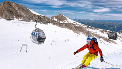 Skiing downhill from high mountains in Zell am See, Austria.