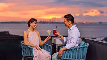 Perched atop The Outpost Hotel, 1-Altitude Coast offers stunning panoramic sea views and vibrant sunsets, perfect for cocktails, relaxation, and unforgettable evenings.