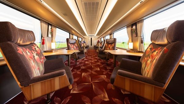 Japan’s Hana Akari, a scenic train by JR West, features plush swivel chairs and private seats, offering journeys through West Japan’s natural beauty and cultural landmarks. Japan’s Hana Akari, a scenic train by JR West, features plush swivel chairs and private seats, offering journeys through West Japan’s natural beauty and cultural landmarks.