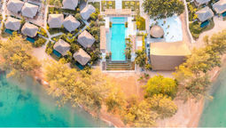 JATI features 82 one- and two-bedroom villas, Khmer-inspired design, private pools, wellness treatments, diverse dining, recreational activities, and family-friendly facilities on a secluded Cambodian island retreat.