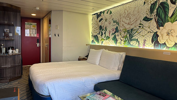 Resorts World One's balcony stateroom features elegant decor, a comfortable bed, spacious seating, modern amenities, and a private balcony offering stunning ocean views for ultimate relaxation. Resorts World One's balcony stateroom features elegant decor, a comfortable bed, spacious seating, modern amenities, and a private balcony offering stunning ocean views for ultimate relaxation.